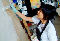 Pauletta painting at the studio.